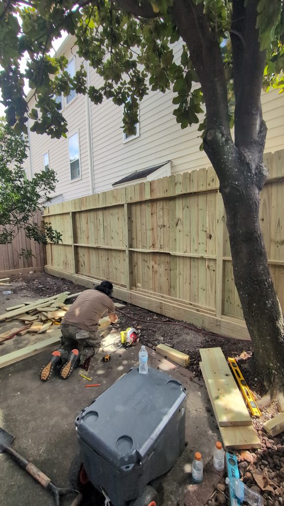 fence being installed at a home in Houston by Nature Springs Landscaping