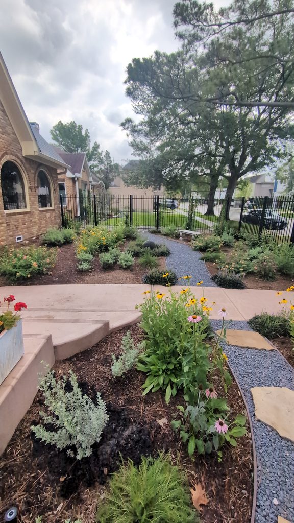 concrete and stone walkway at a home in Houston designed and installed by Nature Springs Landscaping